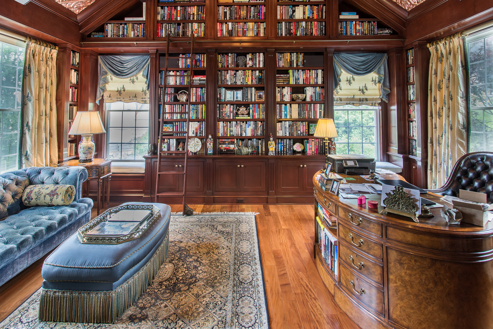 Large traditional home office in New York with medium hardwood floors, no fireplace and a built-in desk.