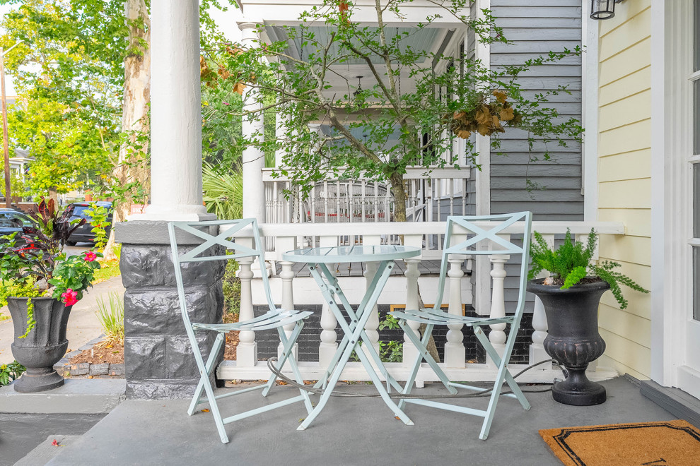 Inspiration for a large transitional yellow two-story wood and clapboard house exterior remodel with a hip roof, a shingle roof and a gray roof