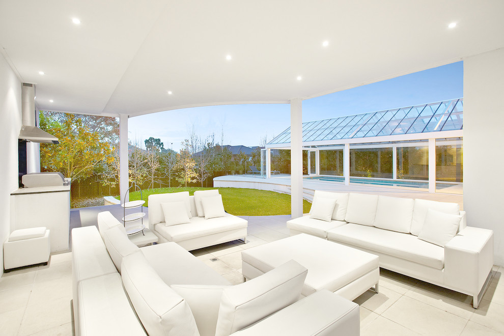 Photo of a contemporary patio in Melbourne with a roof extension.