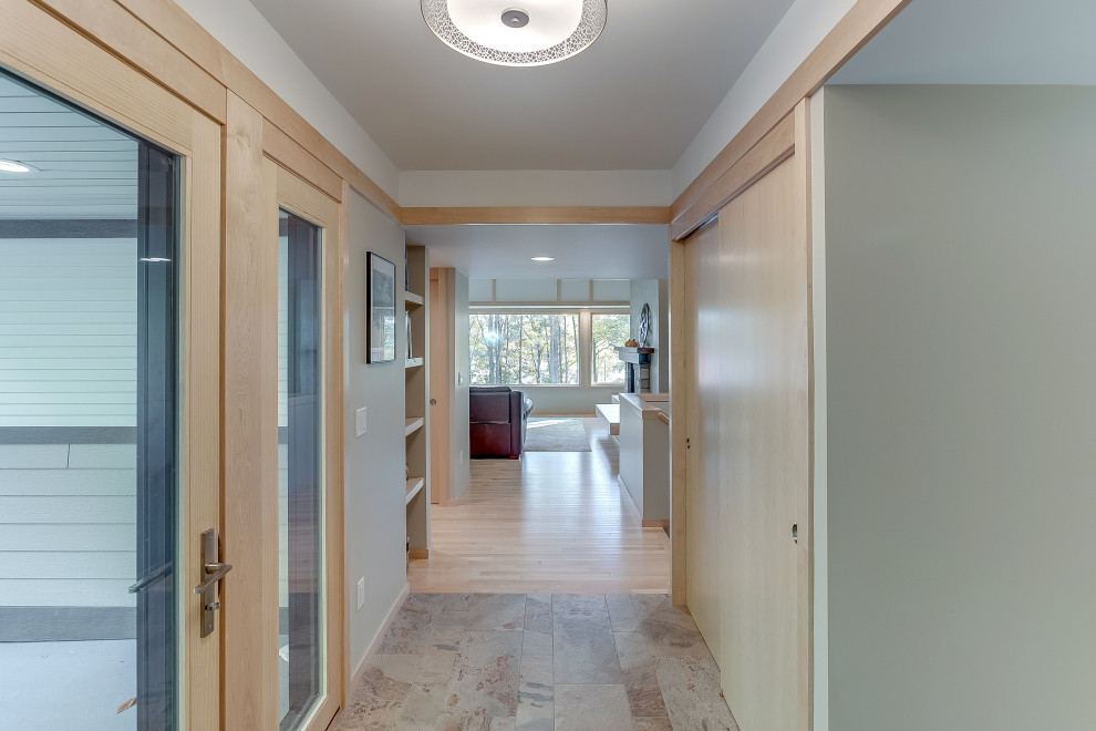 Inspiration for a mid-sized rustic slate floor and beige floor foyer remodel with beige walls and a light wood front door