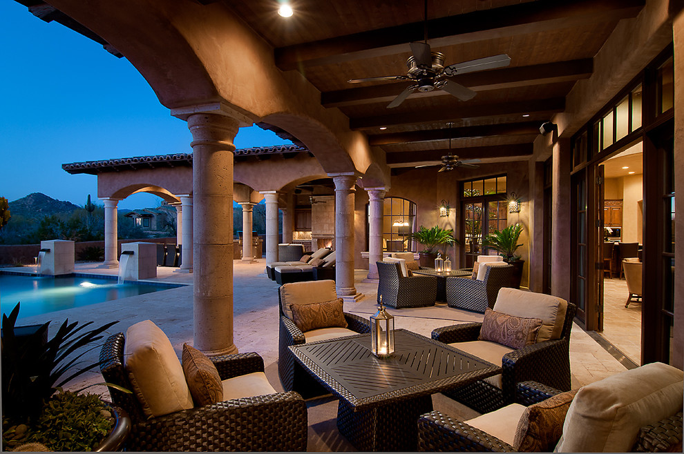 Mediterranean patio in Phoenix with a roof extension.