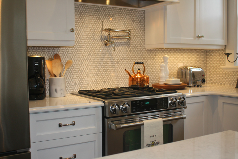 Mid-sized transitional l-shaped kitchen photo with shaker cabinets, white cabinets, white backsplash, stainless steel appliances, an island, a double-bowl sink and mosaic tile backsplash