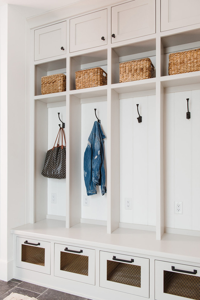 Large country mudroom in Salt Lake City with white walls, ceramic floors and grey floor.