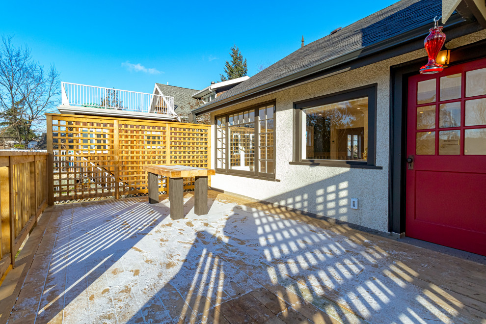 Deck - mid-sized transitional backyard second story privacy and wood railing deck idea