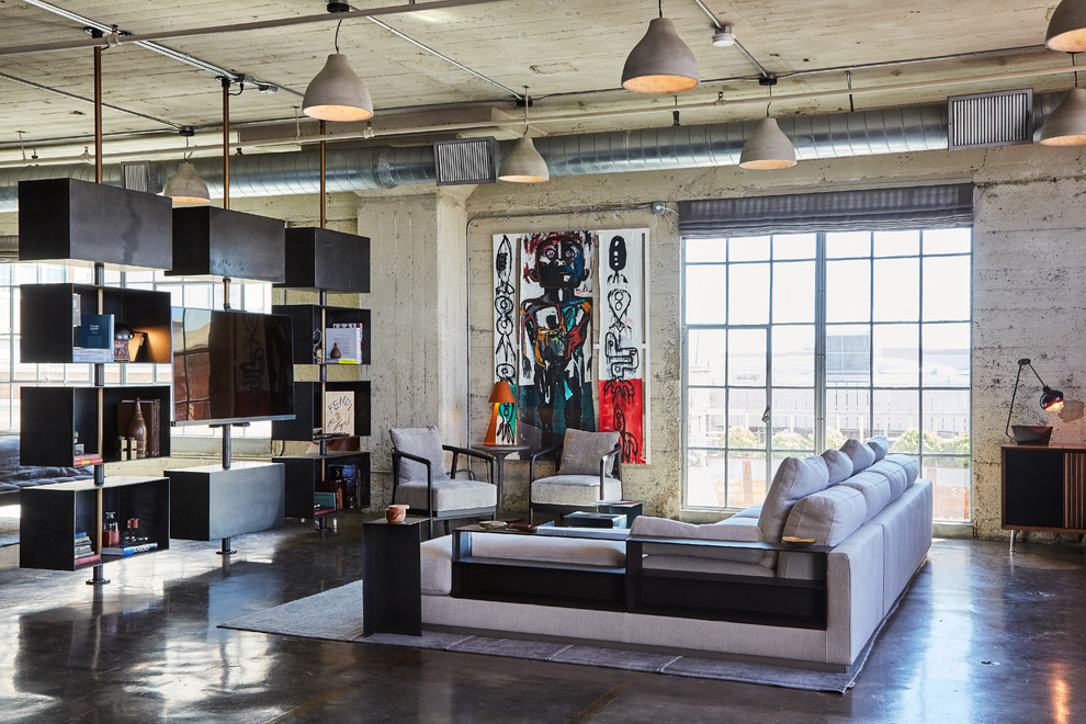 Industrial family room in Los Angeles with concrete floors and grey floor.