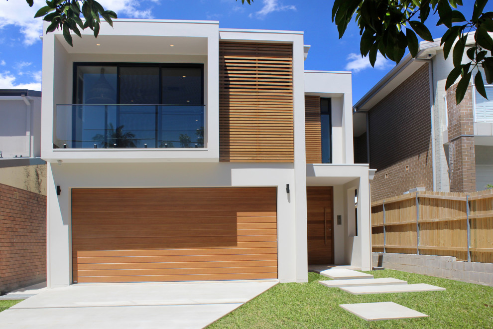 Large contemporary two-storey multi-coloured house exterior in Sydney with mixed siding and a flat roof.