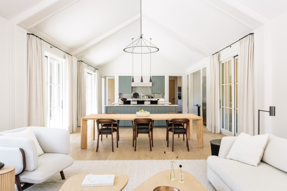 This is an example of a large country open plan dining in San Francisco with vaulted and light hardwood floors.