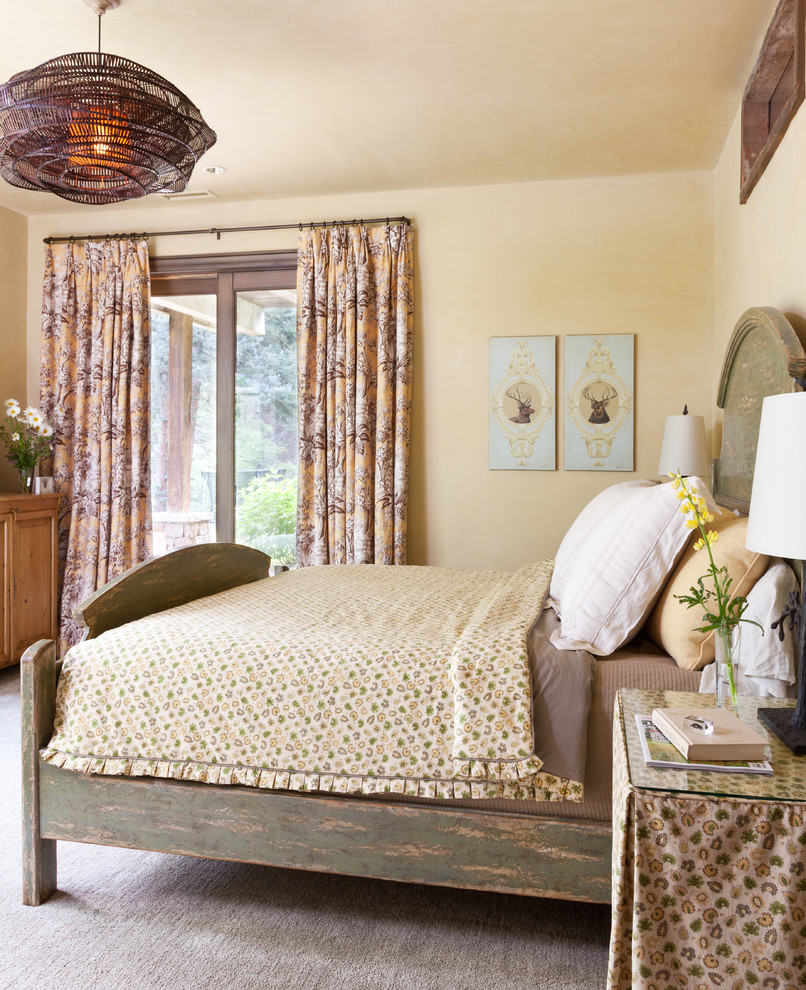 Inspiration for a country bedroom in Other with beige walls and carpet.