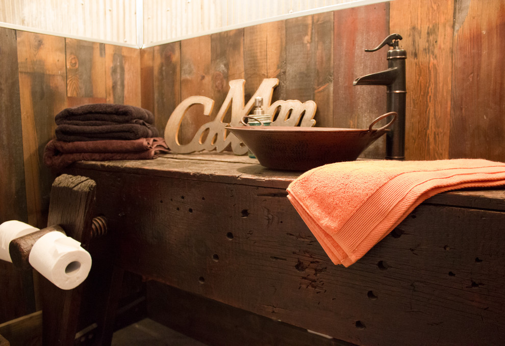 Mid-sized mountain style bathroom photo in Cedar Rapids with dark wood cabinets, wood countertops and a vessel sink