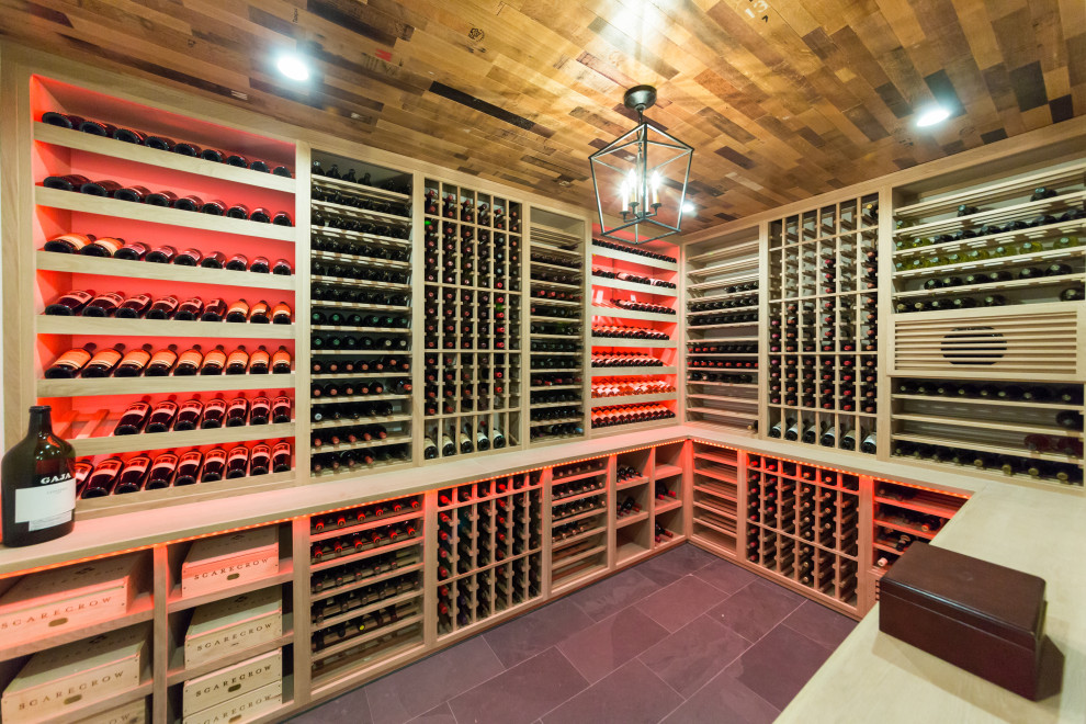 Inspiration for a mid-sized country wine cellar in New York with slate floors, storage racks and black floor.