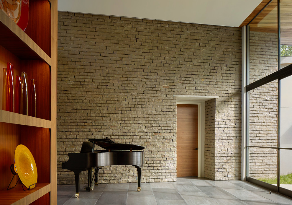 Large contemporary foyer in Dallas with brown walls and grey floor.