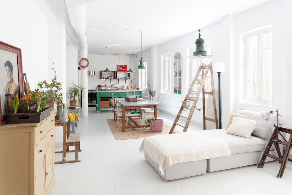 Photo of a large eclectic open concept family room in Madrid with white walls and white floor.