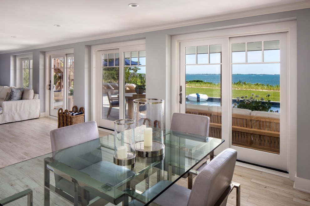 Beach style open plan dining in New York with grey walls.