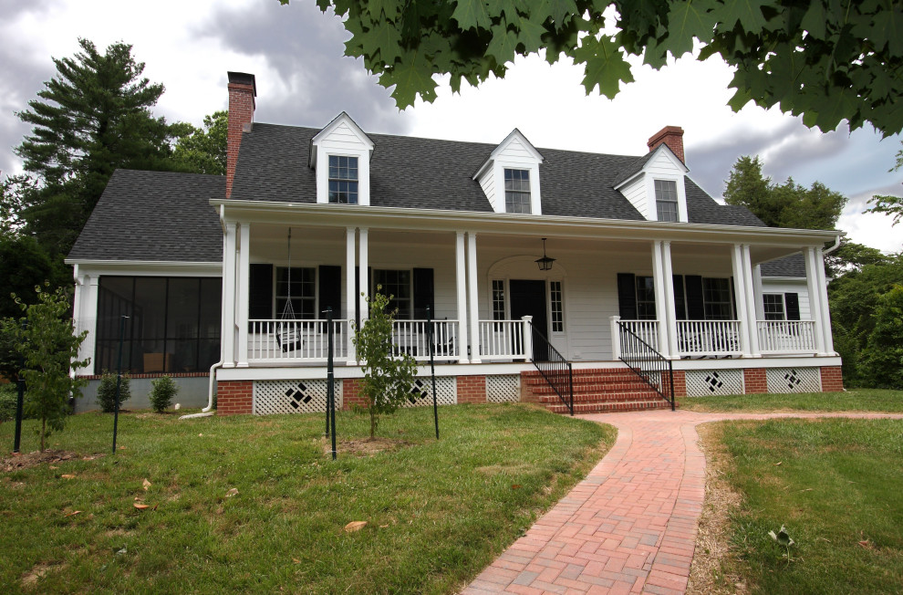 Example of a white three-story vinyl house exterior design with a shingle roof