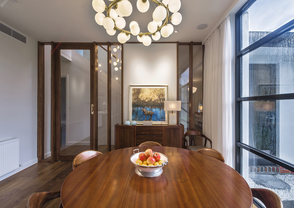 Design ideas for a mid-sized contemporary open plan dining in Melbourne with white walls, medium hardwood floors and brown floor.