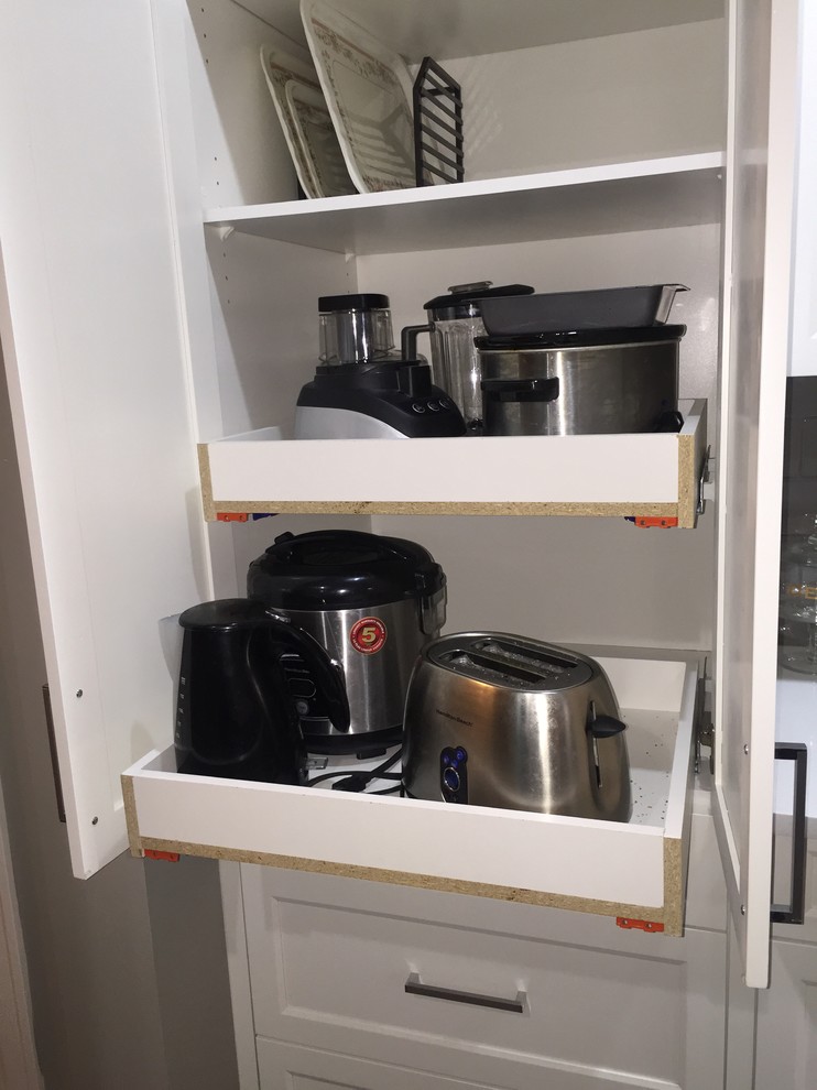 Inspiration for a mid-sized single-wall dark wood floor eat-in kitchen remodel in Calgary with an undermount sink, shaker cabinets, white cabinets, quartzite countertops, gray backsplash, subway tile backsplash, stainless steel appliances and an island
