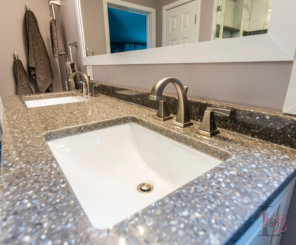 Inspiration for a mid-sized transitional porcelain tile and brown floor eat-in kitchen remodel with an undermount sink, recessed-panel cabinets, white cabinets, quartz countertops, gray backsplash, subway tile backsplash, stainless steel appliances, an island and white countertops