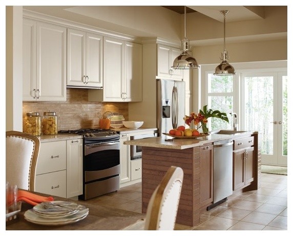 Example of a small transitional single-wall travertine floor open concept kitchen design in Toronto with an undermount sink, recessed-panel cabinets, white cabinets, granite countertops, beige backsplash, stone tile backsplash, stainless steel appliances and an island