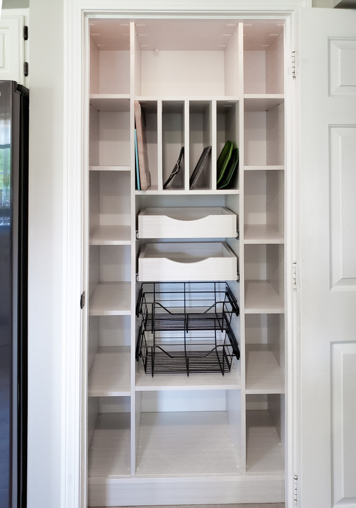 Inspiration for a small reach-in closet remodel in Burlington with open cabinets and light wood cabinets