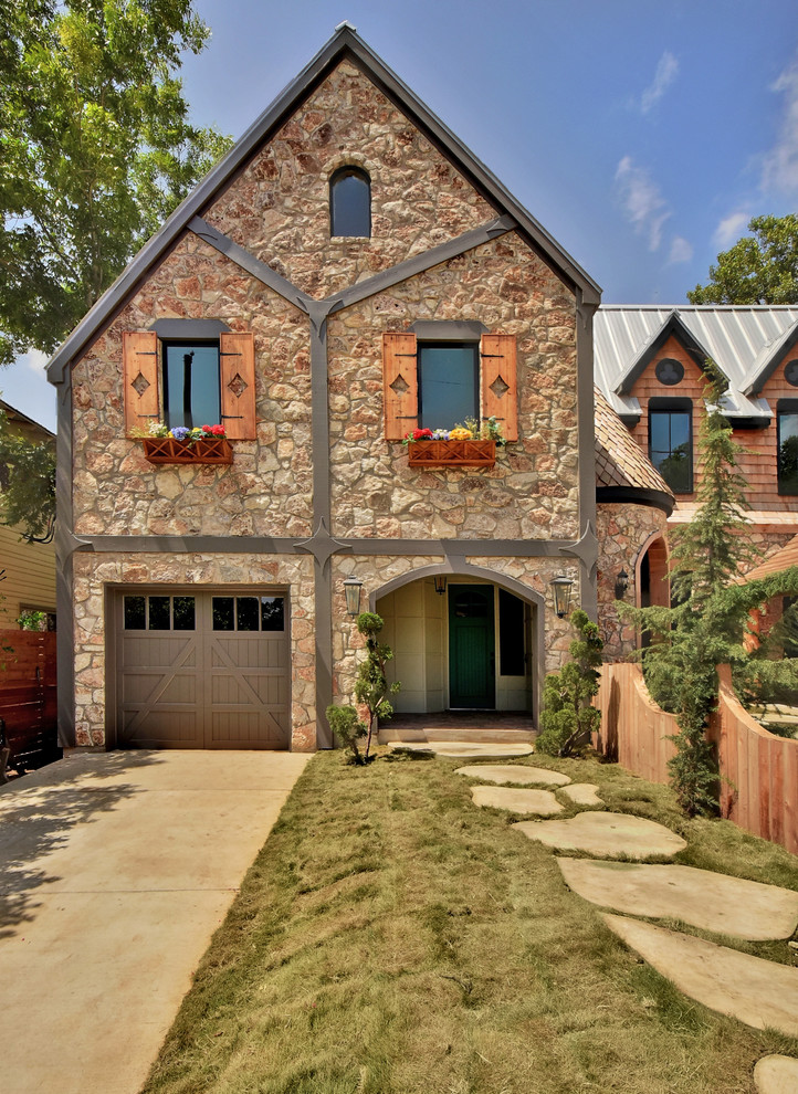 Photo of a traditional two-storey exterior in Austin with stone veneer and a gable roof.