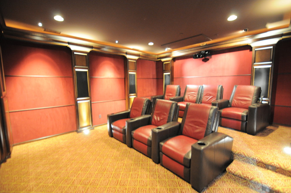 Large transitional enclosed carpeted home theater photo in Los Angeles with red walls and a projector screen