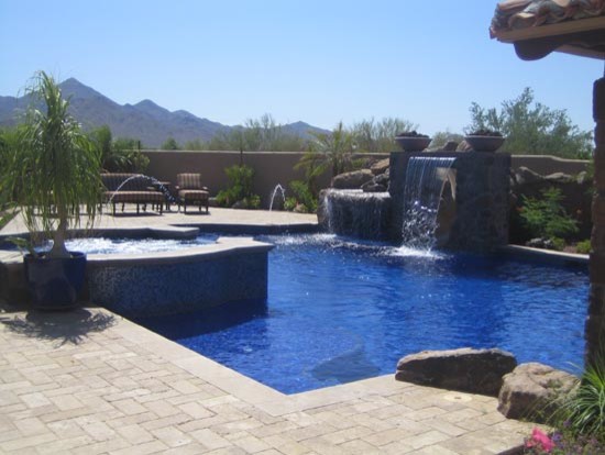 Inspiration for a large transitional backyard brick and custom-shaped hot tub remodel in Phoenix