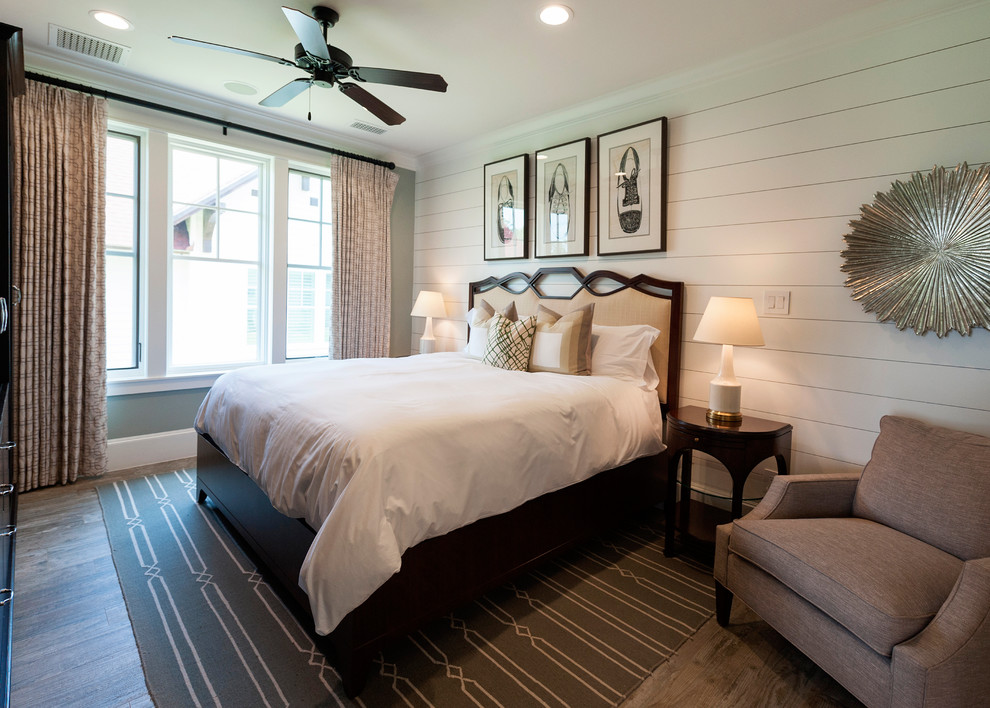 Design ideas for a mid-sized traditional guest bedroom in Houston with multi-coloured walls, medium hardwood floors, no fireplace, brown floor and planked wall panelling.