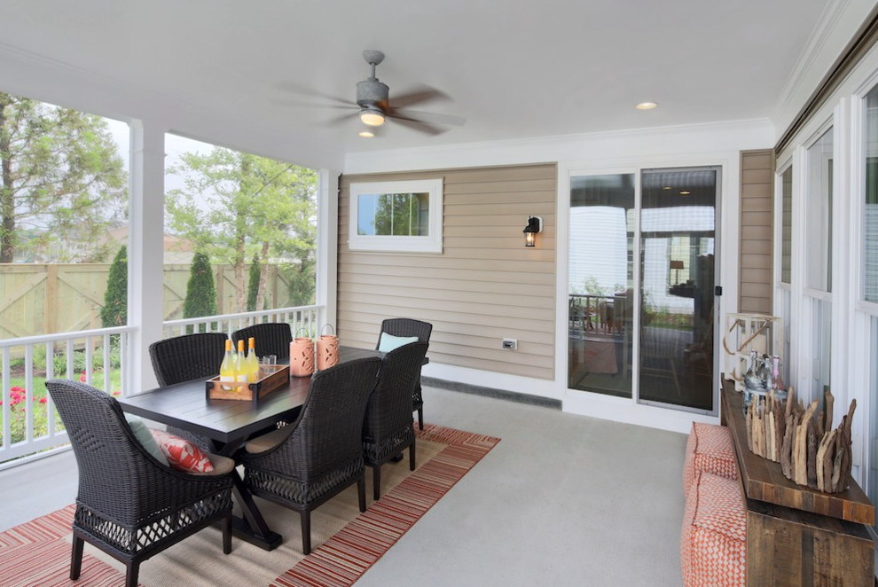 Example of a beach style backyard deck design with an awning