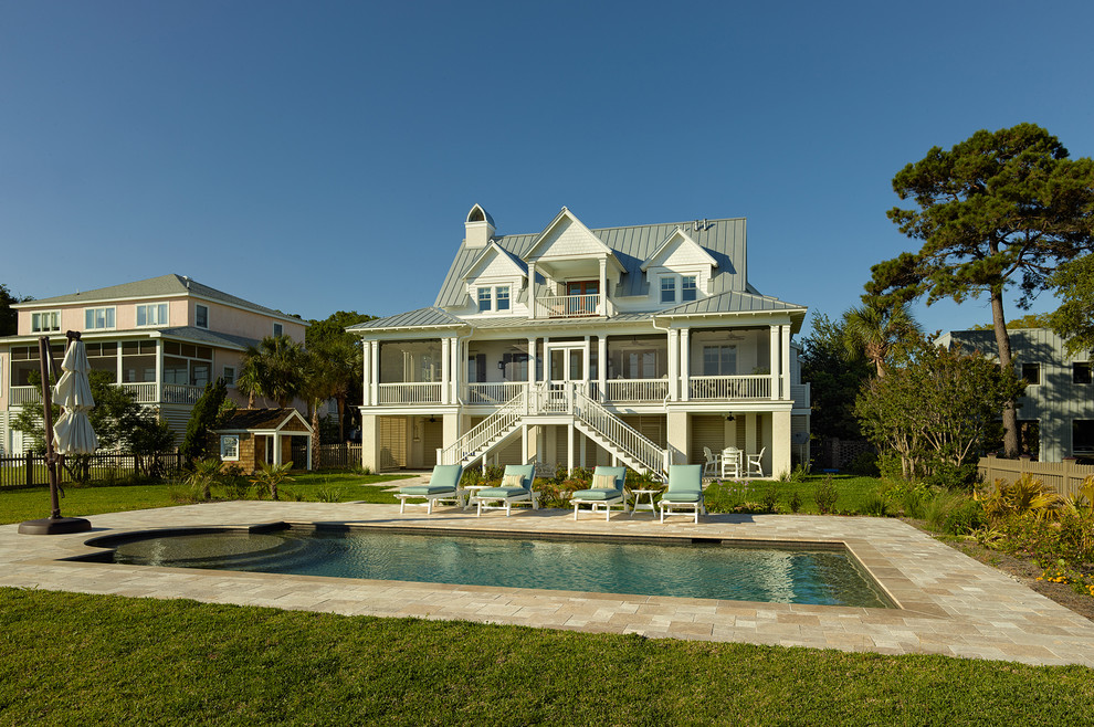 This is an example of a beach style three-storey exterior in Charleston with wood siding.