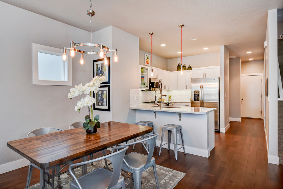 Contemporary kitchen/dining combo in Boise with medium hardwood floors and grey walls.