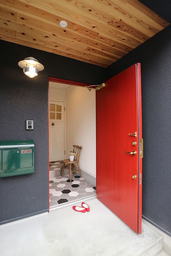 Inspiration for a modern front door in Other with black walls, ceramic floors, a single front door and a red front door.