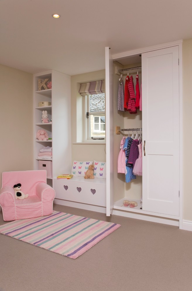 Photo of a transitional kids' room for girls in Gloucestershire with beige walls and carpet.