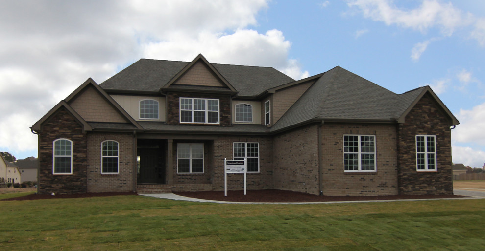 Inspiration for a large transitional two-storey brown exterior in Raleigh with mixed siding.