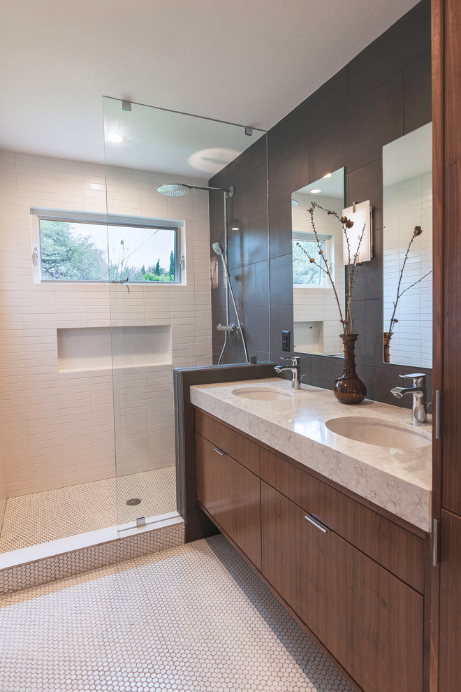 Mid-sized midcentury 3/4 bathroom in Austin with flat-panel cabinets, medium wood cabinets, gray tile, porcelain tile, white walls, mosaic tile floors, an undermount sink, engineered quartz benchtops, white floor, an open shower and white benchtops.