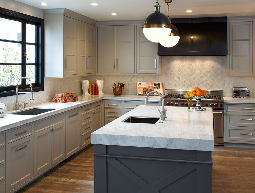 This is an example of a contemporary kitchen in San Francisco with marble benchtops, stainless steel appliances, recessed-panel cabinets, grey cabinets, white splashback and glass tile splashback.