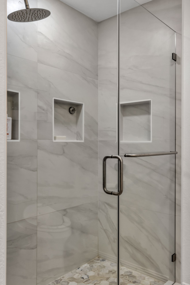Photo of a small modern 3/4 bathroom in Phoenix with flat-panel cabinets, brown cabinets, an alcove shower, a two-piece toilet, grey walls, ceramic floors, engineered quartz benchtops, a hinged shower door, white benchtops, a double vanity, a floating vanity, brick walls, an undermount sink, ceramic tile, gray tile and multi-coloured floor.