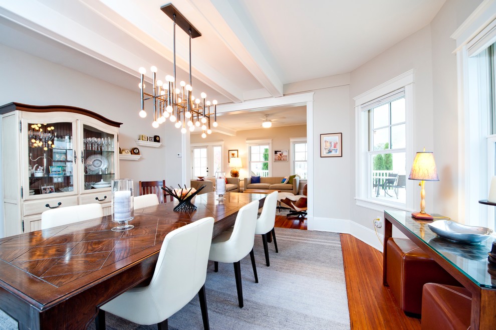 This is an example of a mid-sized transitional separate dining room in New York with grey walls, medium hardwood floors and no fireplace.