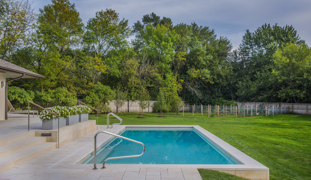 Pool - mid-sized modern backyard stone and rectangular pool idea in Chicago