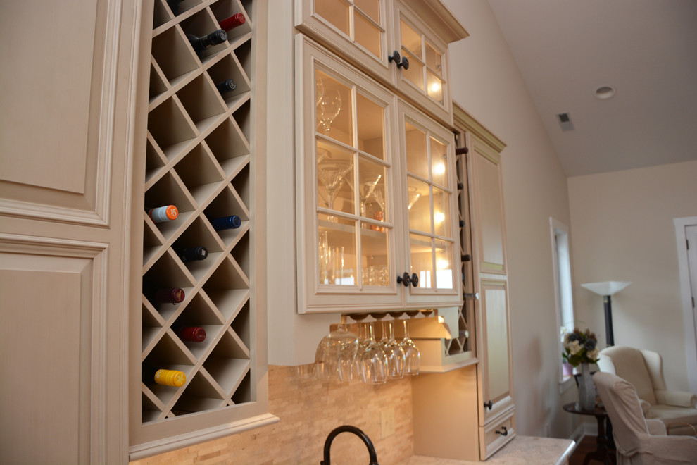 Inspiration for a small traditional single-wall wet bar in Baltimore with an undermount sink, raised-panel cabinets, beige cabinets, quartz benchtops, beige splashback, stone tile splashback, dark hardwood floors, brown floor and white benchtop.