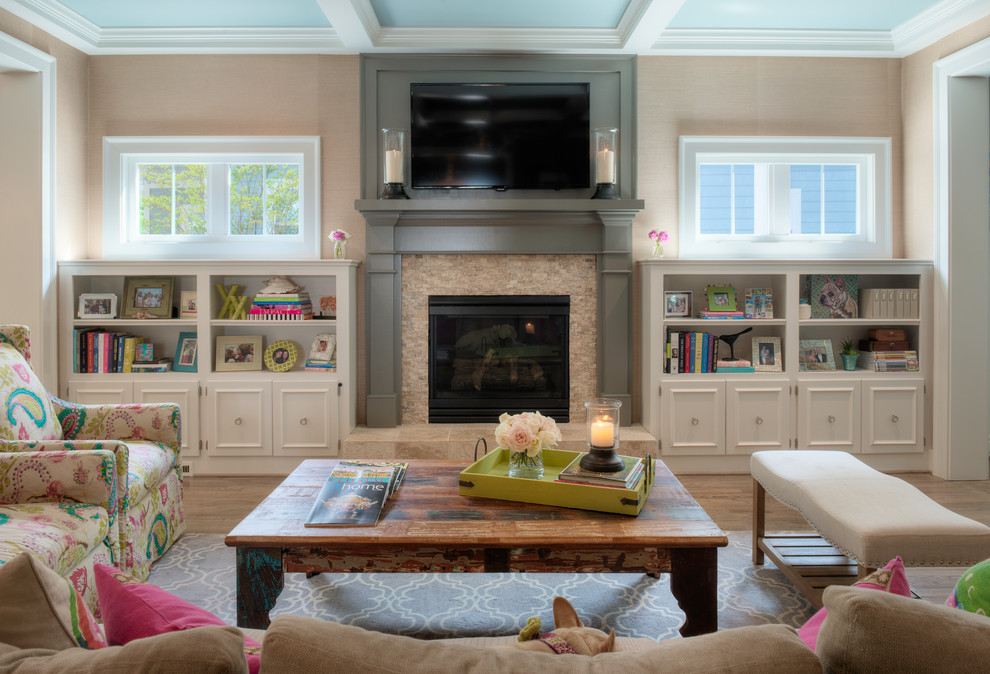 Inspiration for a mid-sized transitional open concept living room in Other with beige walls, medium hardwood floors, a standard fireplace, a stone fireplace surround and a wall-mounted tv.