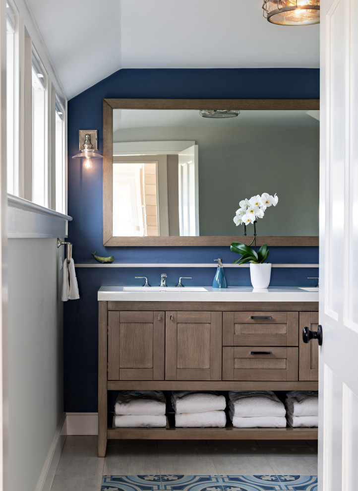 Photo of a beach style bathroom in Boston with shaker cabinets, medium wood cabinets, blue walls, dark hardwood floors, an undermount sink, brown floor, white benchtops, a double vanity and a freestanding vanity.