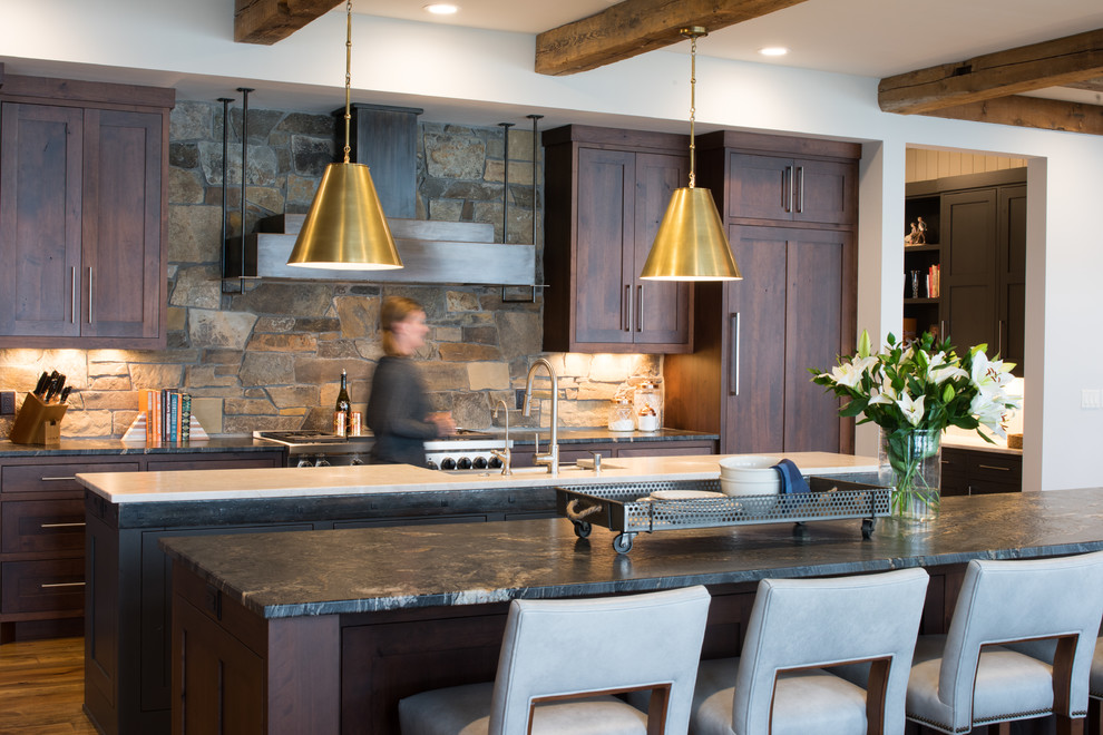 Design ideas for a country kitchen in Minneapolis with shaker cabinets, dark wood cabinets, stainless steel appliances, medium hardwood floors, multiple islands and black benchtop.
