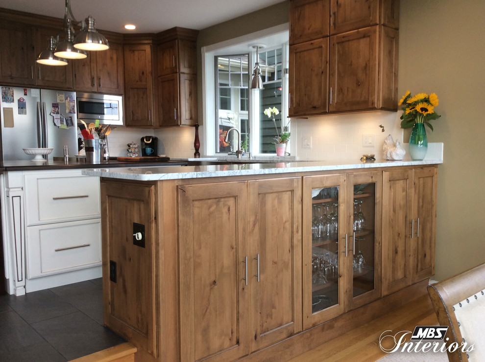 Inspiration for a mid-sized transitional u-shaped ceramic tile and gray floor eat-in kitchen remodel with a farmhouse sink, recessed-panel cabinets, medium tone wood cabinets, marble countertops, white backsplash, subway tile backsplash, stainless steel appliances and an island