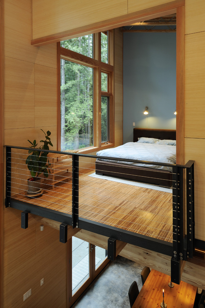 Inspiration for a mid-sized contemporary loft-style bedroom in Seattle with bamboo floors, blue walls and no fireplace.