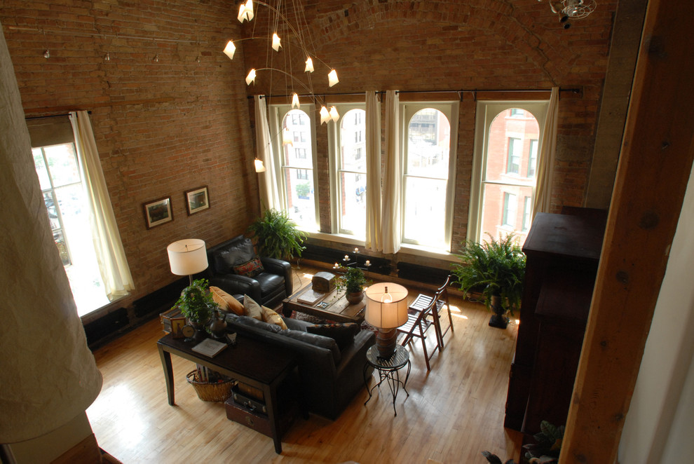 Design ideas for a large arts and crafts loft-style living room in Chicago with white walls and light hardwood floors.