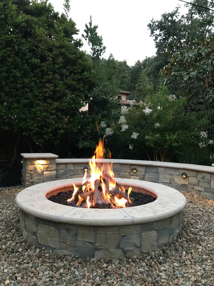 Inspiration for a mediterranean garden in San Francisco with a fire feature and gravel.