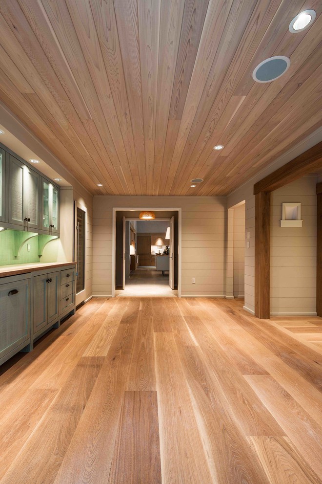 Photo of a large contemporary hallway in DC Metro with grey walls and light hardwood floors.