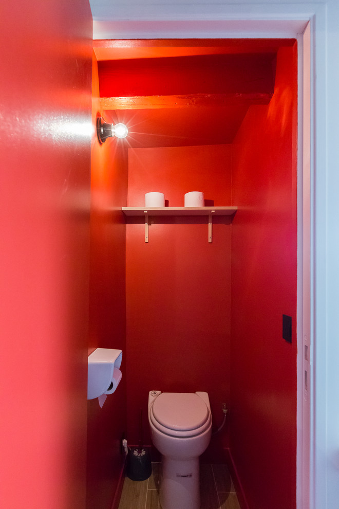 Small contemporary powder room in Paris with beige tile, red walls and ceramic floors.