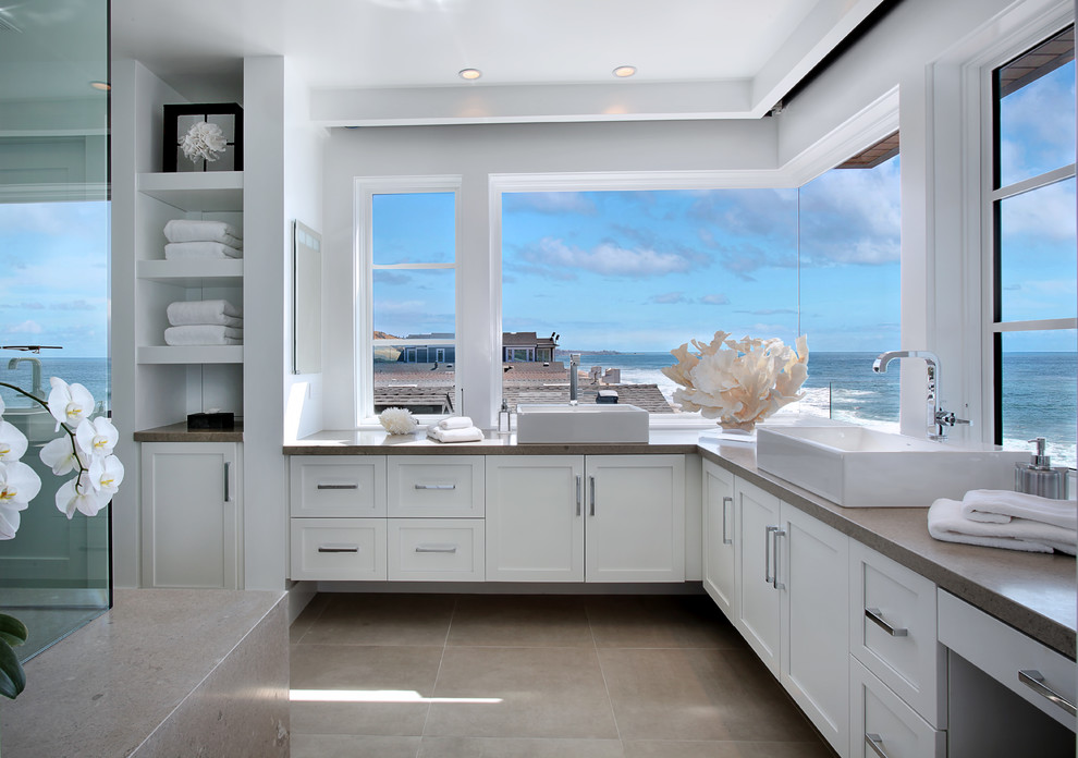 Inspiration for a beach style bathroom in Orange County with a vessel sink, shaker cabinets, white cabinets and white walls.