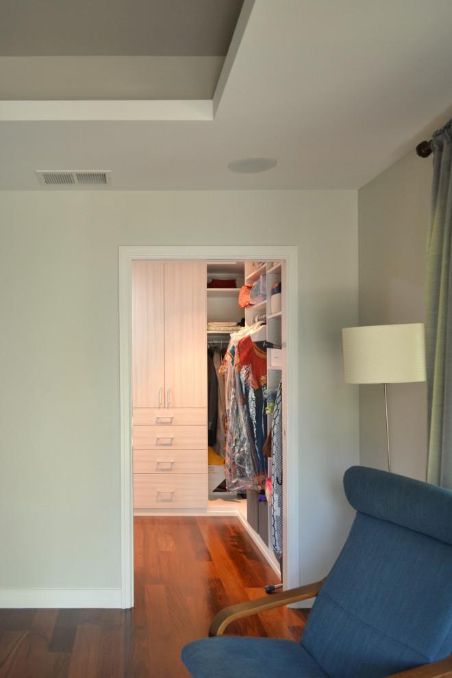 Closet - mid-sized transitional medium tone wood floor, red floor and coffered ceiling closet idea in San Francisco with recessed-panel cabinets and white cabinets